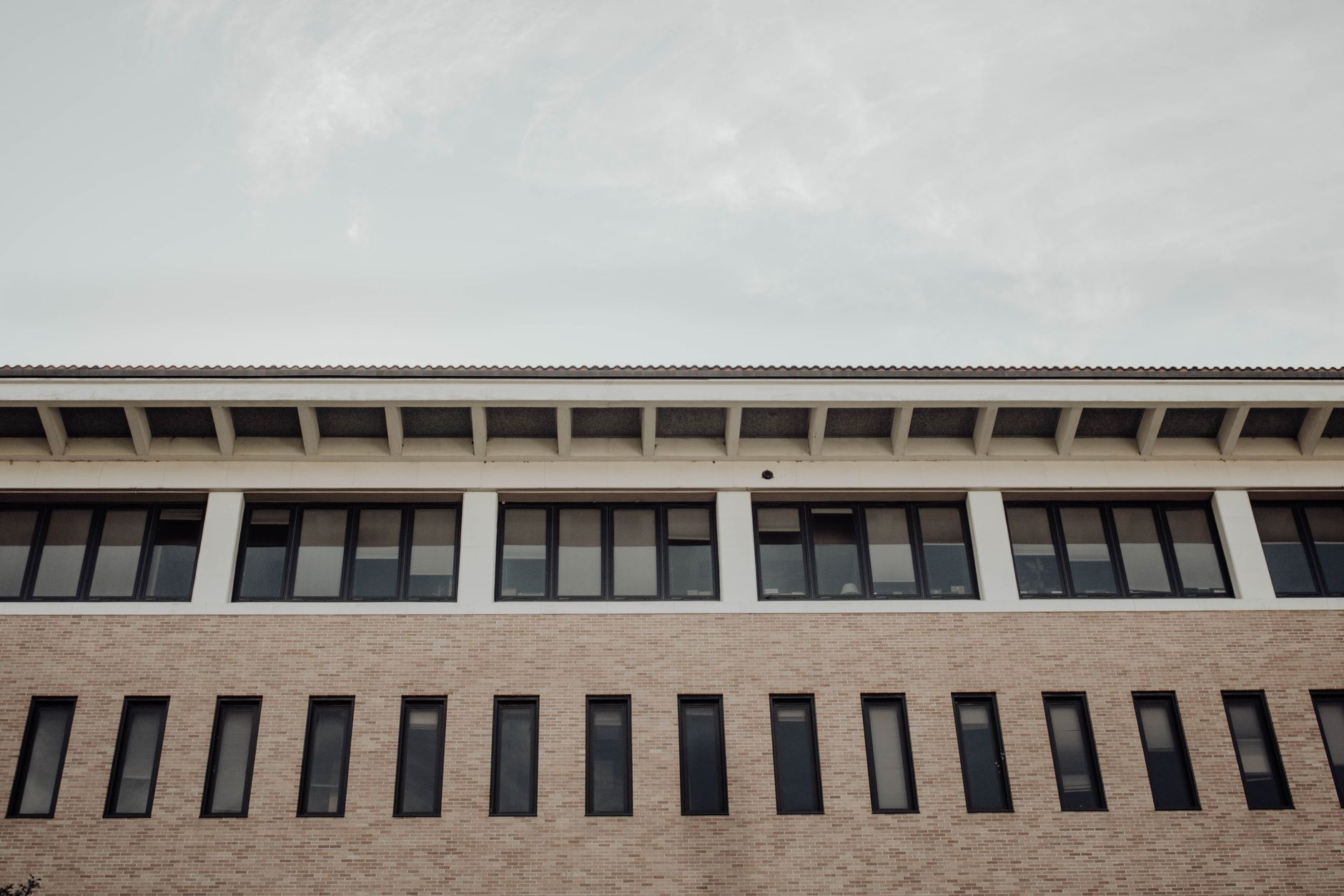 Low angle view of a modern brick building facade with windows in Austin, TX